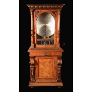 A late 19th century walnut floor standing coin operated polyphon