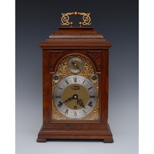 An 18th century style English walnut three-train musical bracket clock
