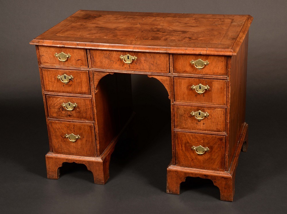 An early 18th century walnut kneehole desk