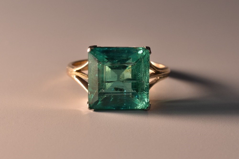 A Columbian square emerald cut emerald solitaire ring