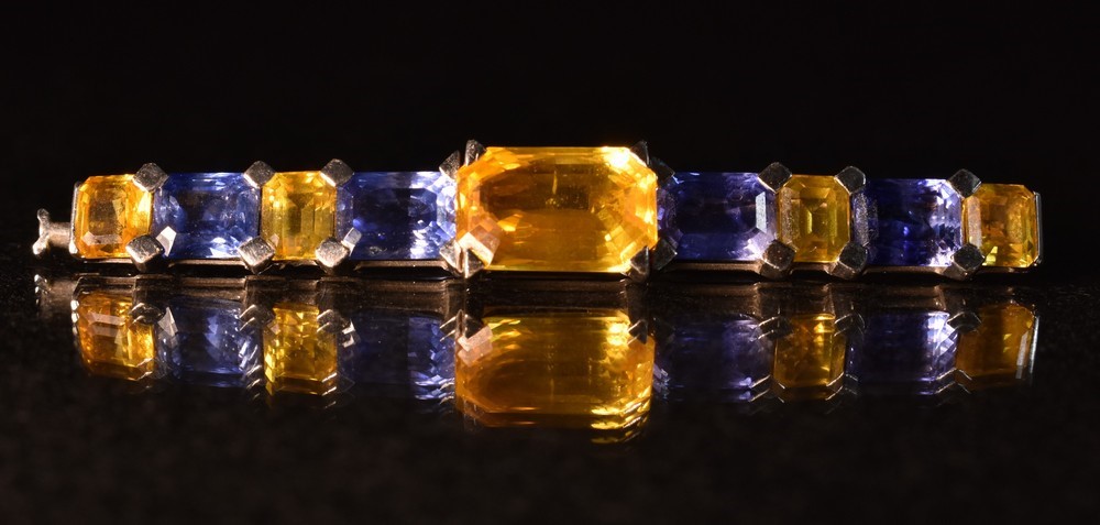 A Hemmerle hand crafted yellow and blue sapphire brooch