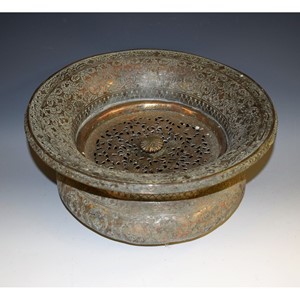 An Islamic copper circular censer