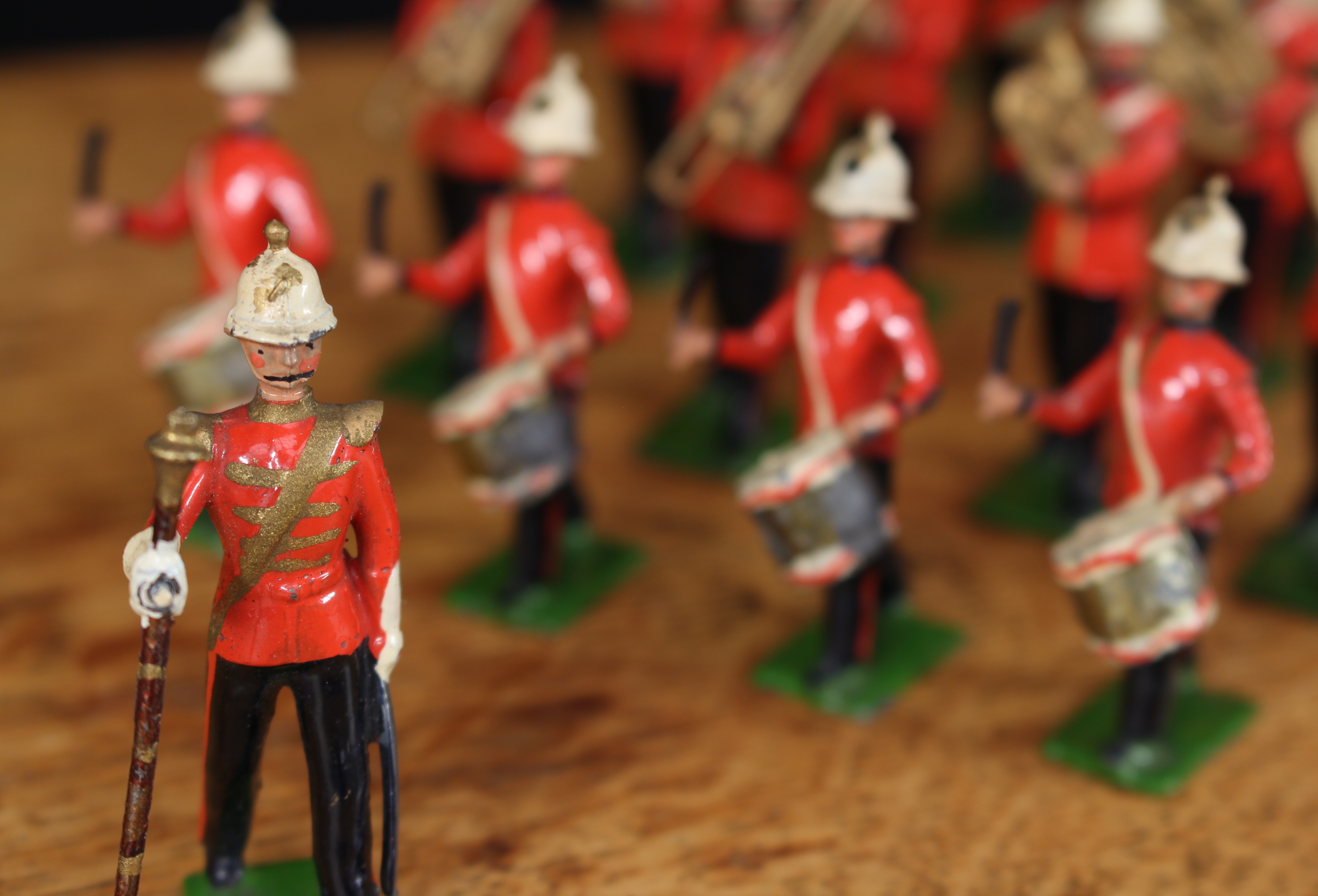 A rare W Britain (Britains) group of twenty one figures from No.1622 Royal Marine Light Infantry Band, each in red tunics with blue collars and cuffs, white helmets, comprising Bandmaster with baton, one cymbalist, four side drummers, one bass drummer, two trombonists, two double bass horn players, three euphonium players, three trumpeters, two clarinettists, fife player and bassoon player, each with rectangular bases, each unboxed (21)