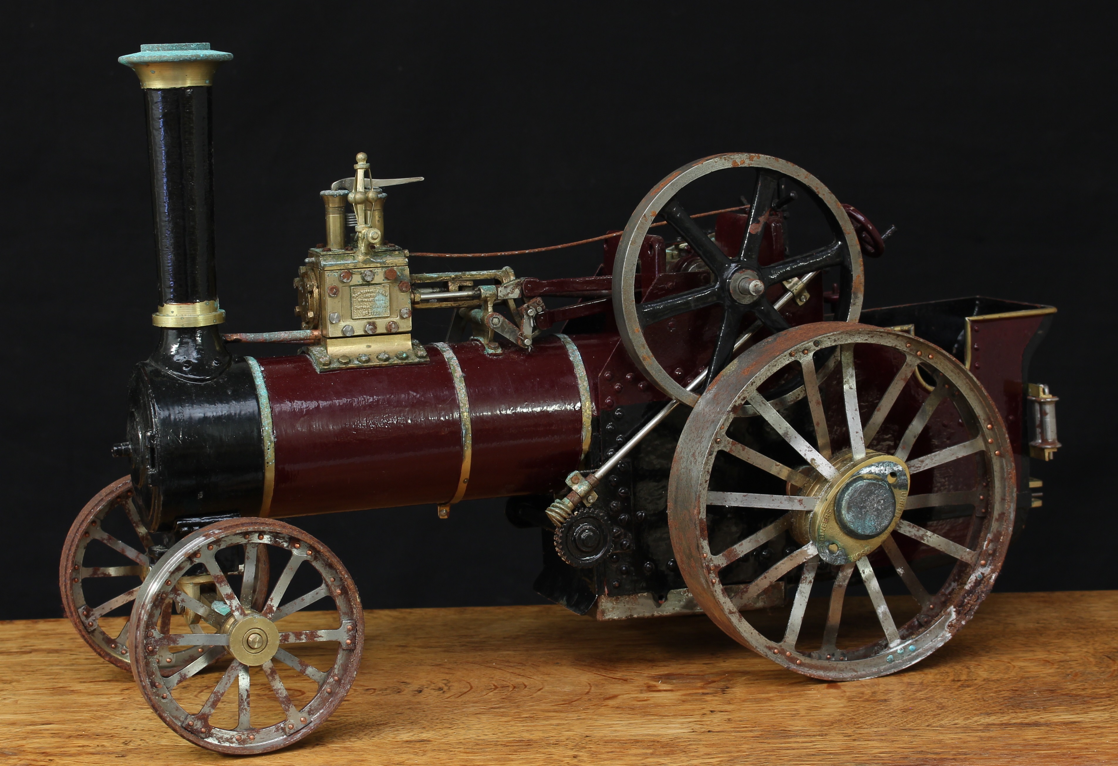 Charles Burrell & Sons Ltd (Engineers, Thetford Norfolk) - a scratch-built live steam agricultural traction engine, unnamed but based on the Prince (7HP) single cylinder tractor, approximately 1 inch scale, maroon livery, single brass topped chimney, rectangular brass plaque to side, 51cm long