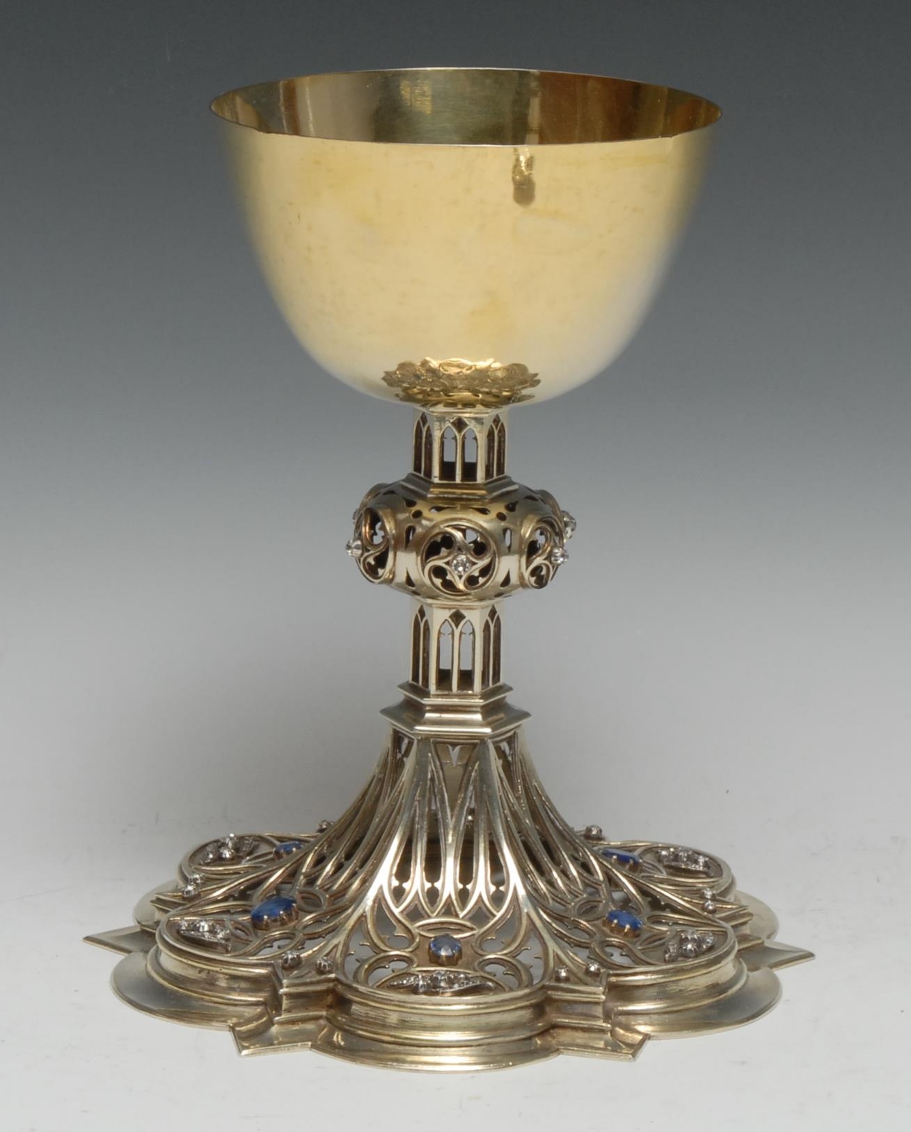 A fine Gothic Revival diamond and sapphire mounted silver-gilt ecclesiastical Communion chalice