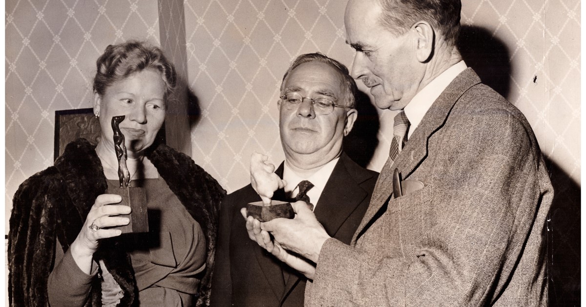 A.L.Pocock shows two of his animal carvings to Percy Bottley and his wife, Winifred at one of his Chelsea Exhibitions in the 1950's.jpg
