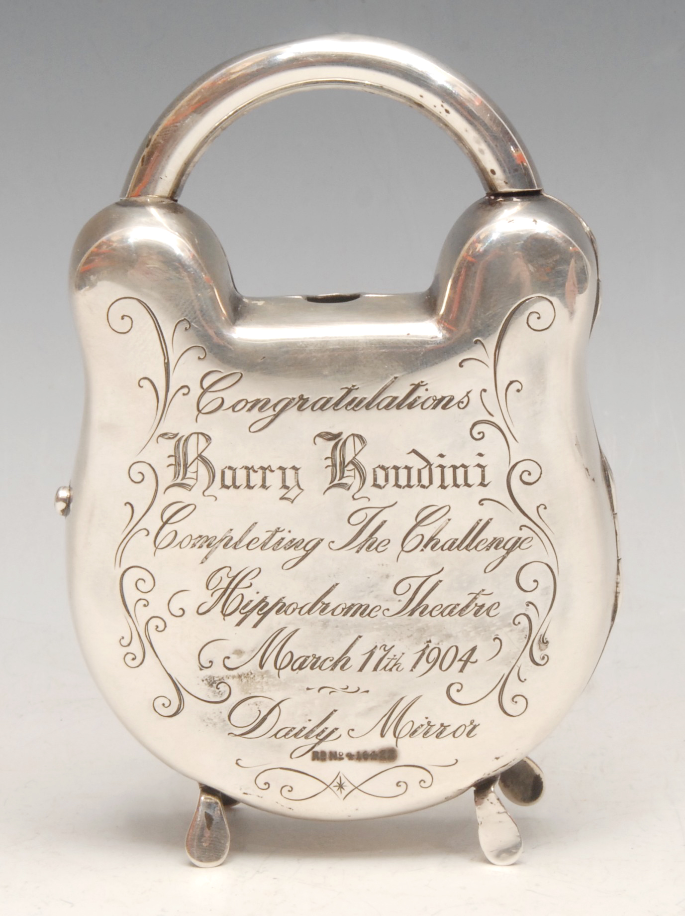 Magic, Conjuring & Escapology - an Edwardian silver novelty pocket watch stand, as a padlock, inscribed to verso Congratulations to Harry Houdini, Completing the Challenge, Hippodrome Theatre, March 17th 1904, Daily Mirror, hinged cover, 11.5cm high, London 1902