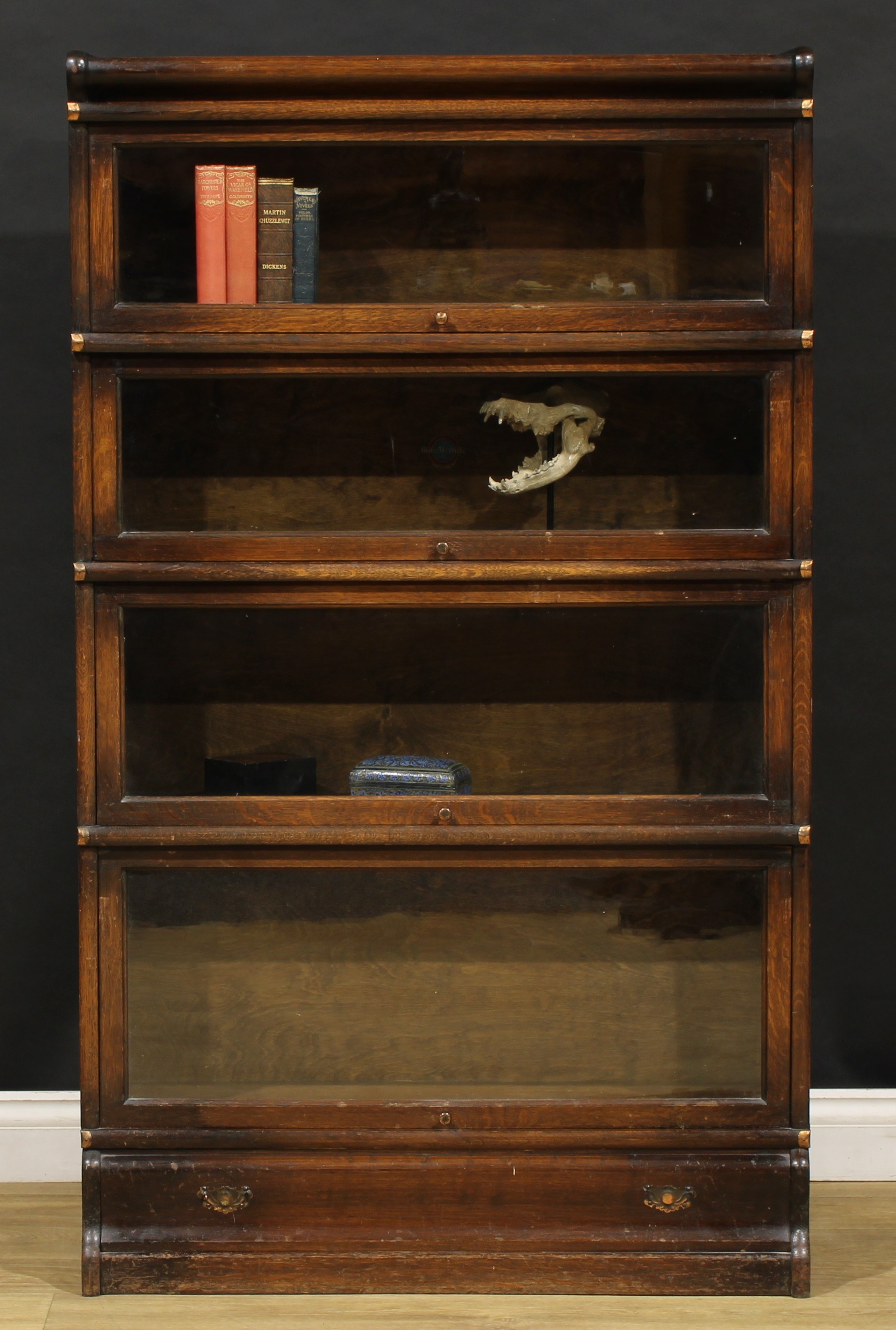 An early 20th century oak barrister's bookcase, by Globe Wernicke, comprising four modular stacking sections, 146.5cm high, 86.5cm wide, 38.5cm deep, 31.5cm deep