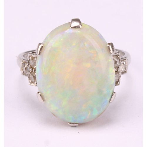 An Art Deco platinum ring, the central large claw set polished opal cabochon, flanked to either side by three single cut diamonds