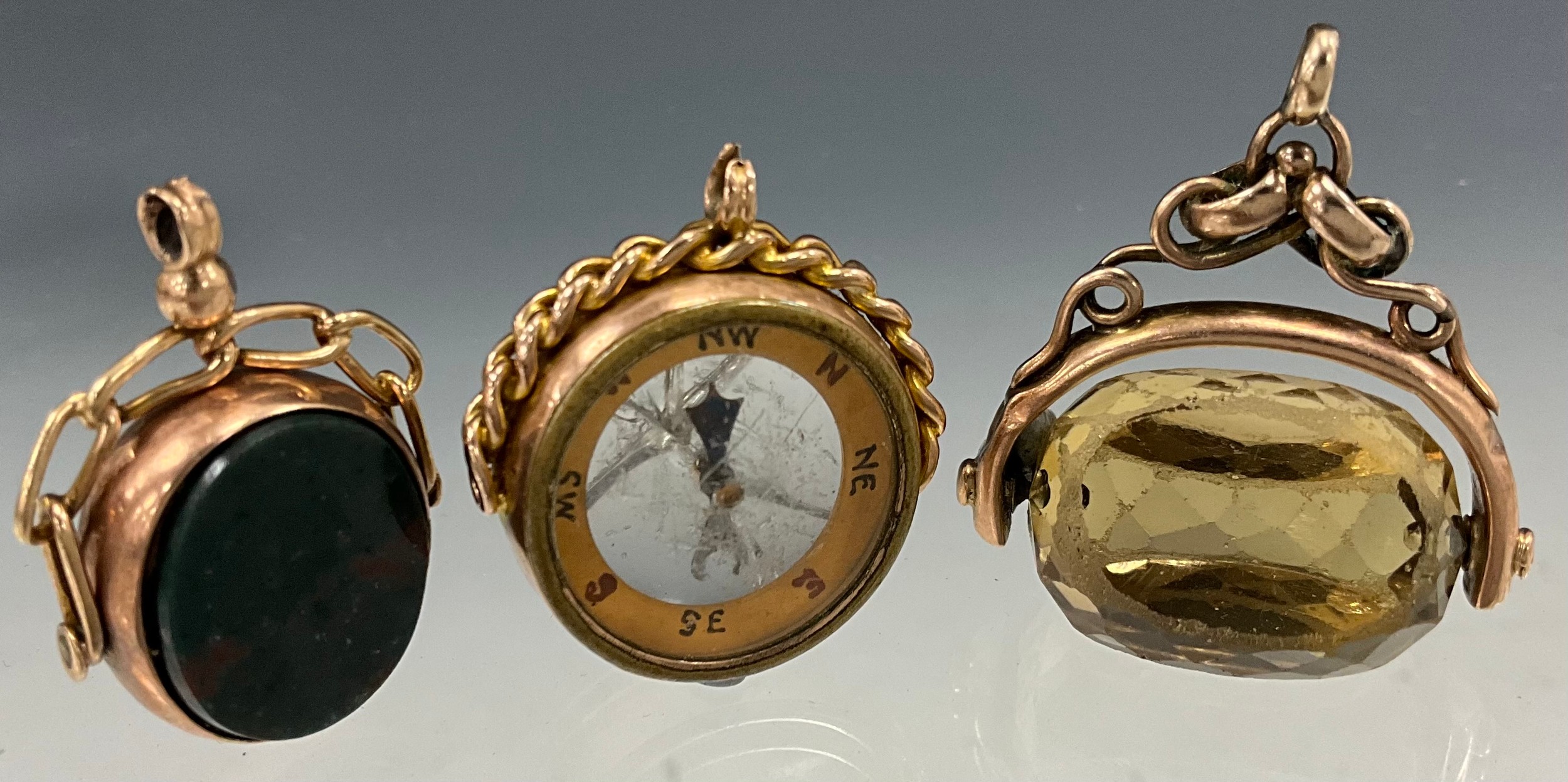 A George V 9ct rose gold mounted compass Chester 1920, 9.1g gross; revolving bloodstone and sardonyx seal stamp, Chester 1920, 4.8g gross; another, pale yellow citrine with unmarked yellow metal mount