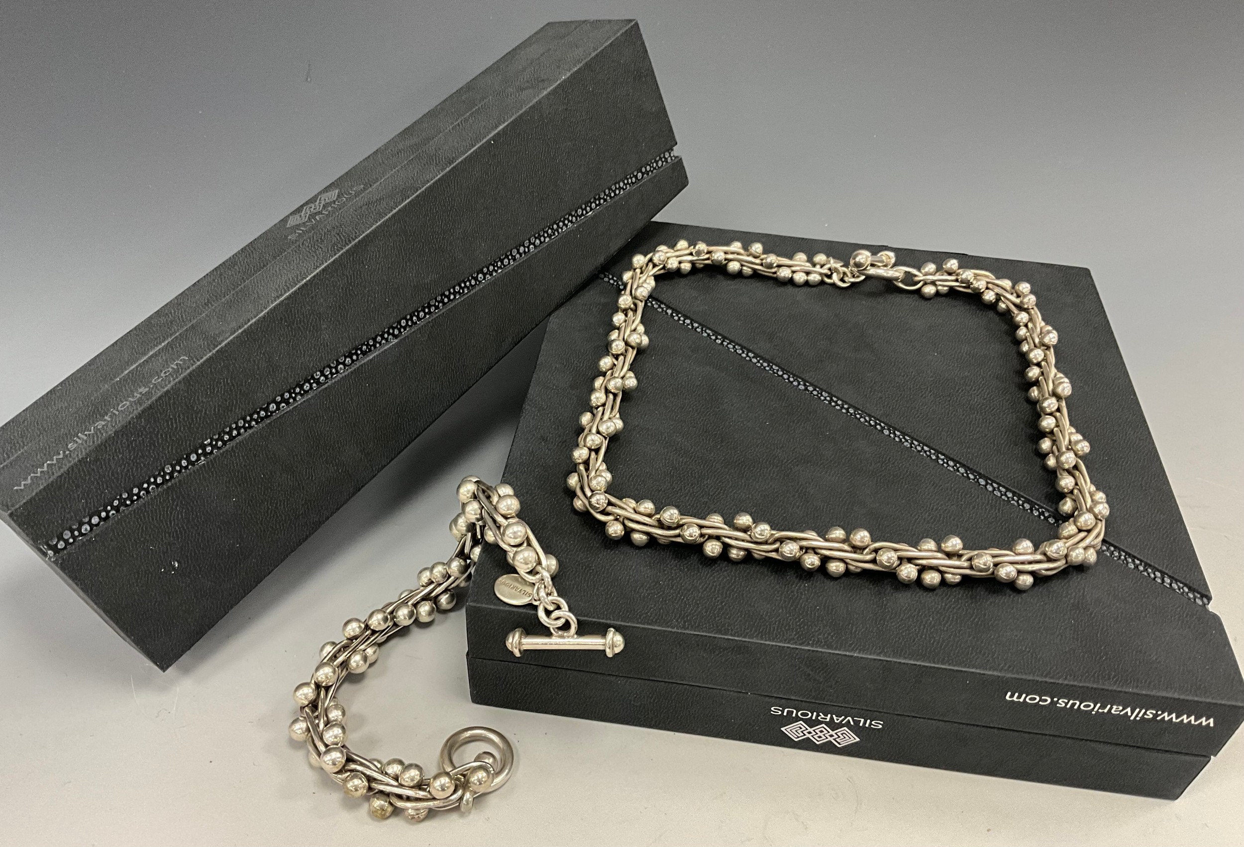 A hand crafted Silvarious sterling silver Berries pattern necklace and bracelet set