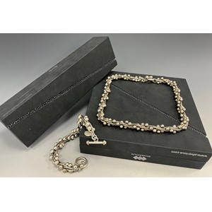 A hand crafted Silvarious sterling silver Berries pattern necklace and bracelet set