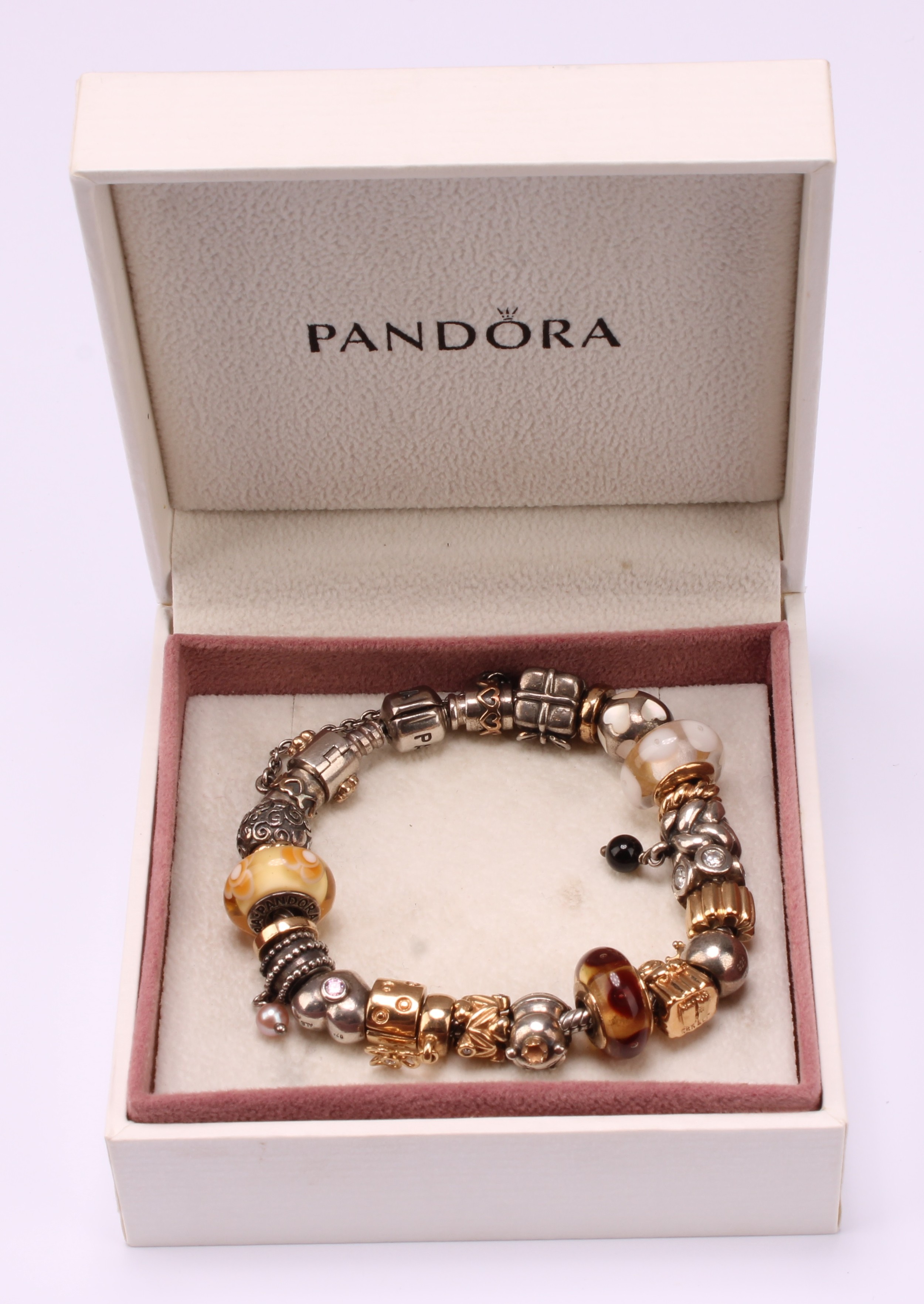 A Pandora charm bracelet, with twenty three 14ct gold, silver and silver gilt charms 
