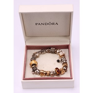 A Pandora charm bracelet, with twenty three 14ct gold, silver and silver gilt charms