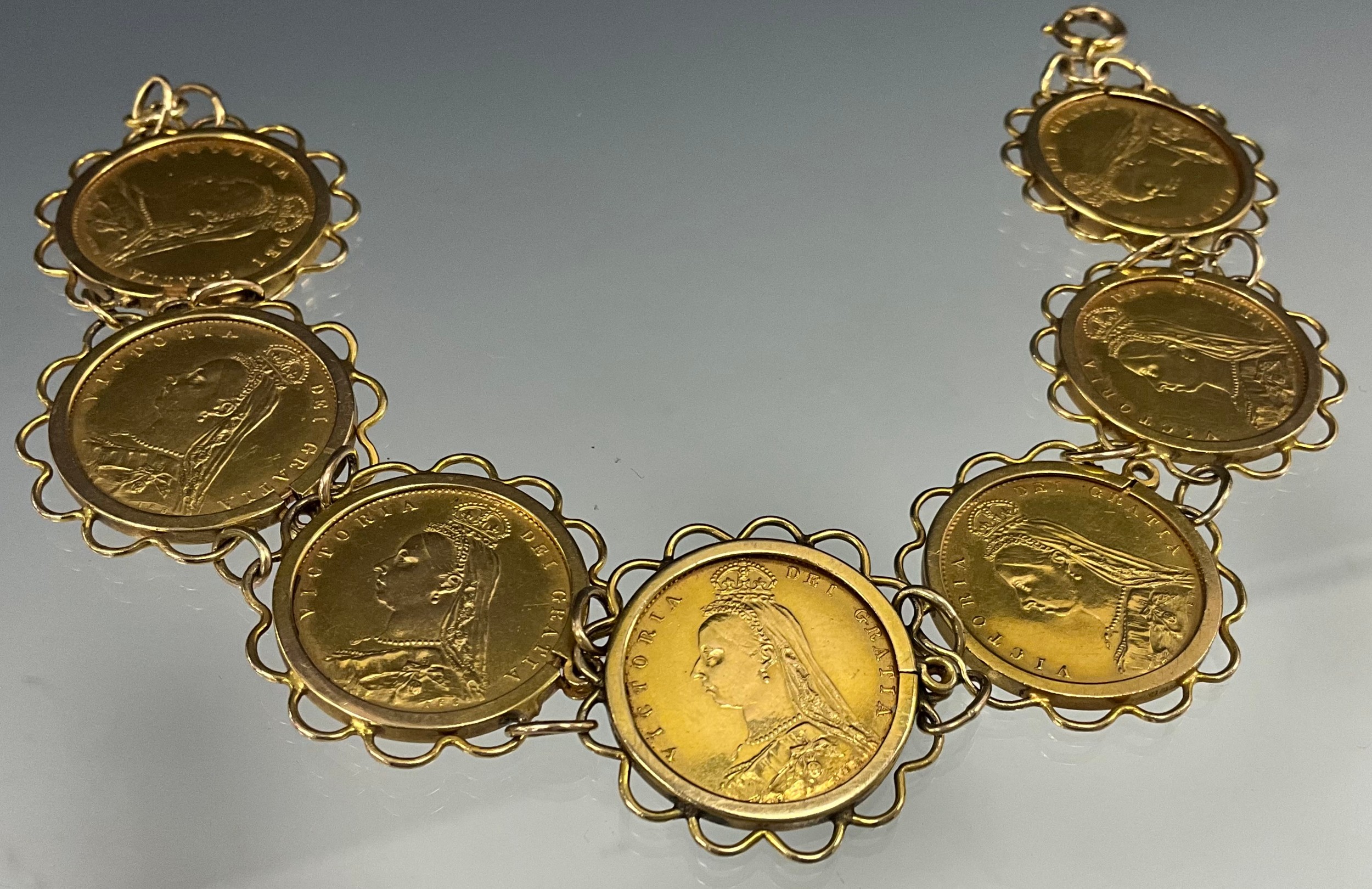 A Victorian half sovereign bracelet, set with seven shield back half sovereigns, all 1887