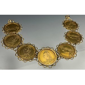 A Victorian half sovereign bracelet, set with seven shield back half sovereigns, all 1887