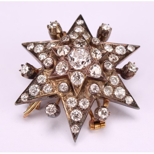An early 20th century diamond set six pointed star pendant brooch