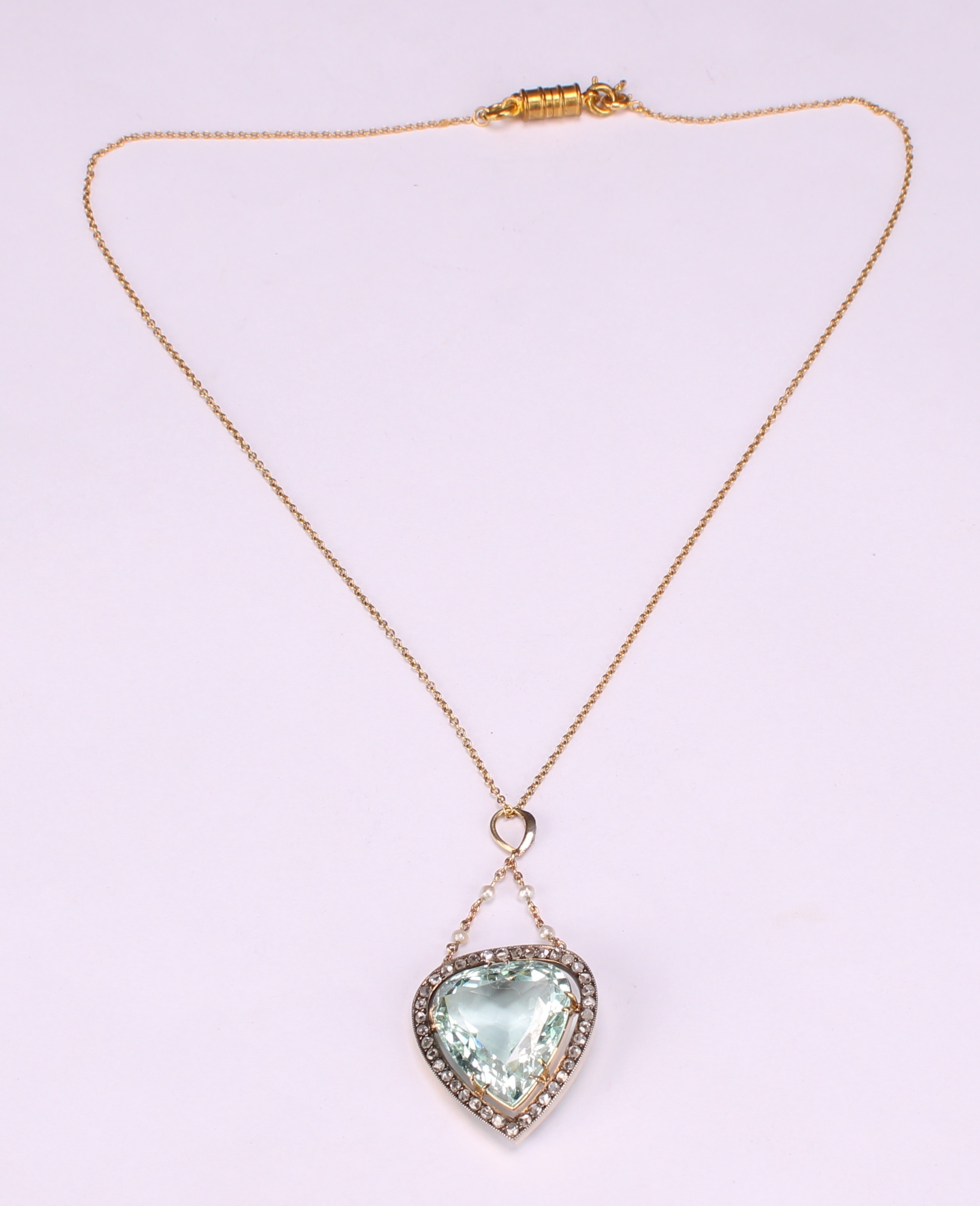 A trilliant cut aquamarine, diamond and gold coloured metal pendant