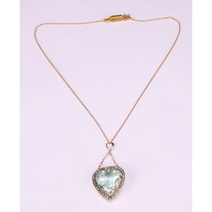 A trilliant cut aquamarine, diamond and gold coloured metal pendant