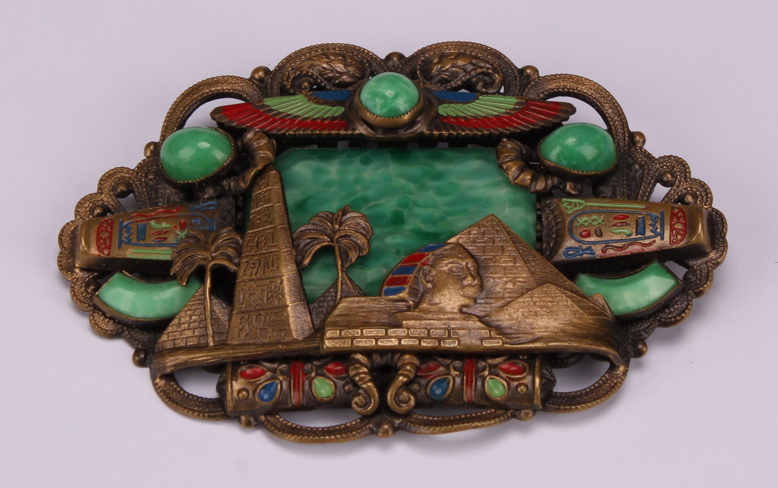 A large Neiger Brothers Egyptian Revival brass cloisonne enamel and Peking malachite glass brooch