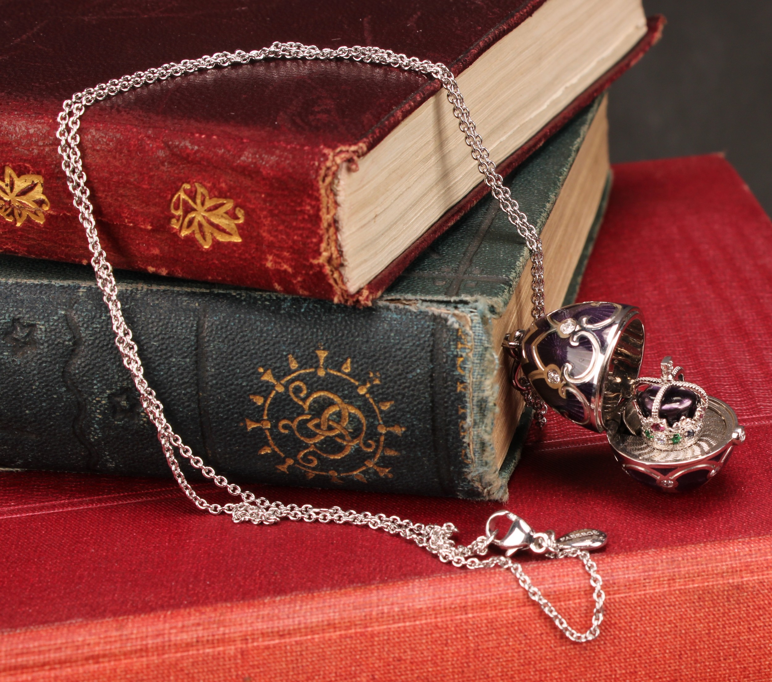 A Fabergé Heritage 18k white gold, diamond and purple guilloche enamel Queen jubilee surprise egg shaped locket