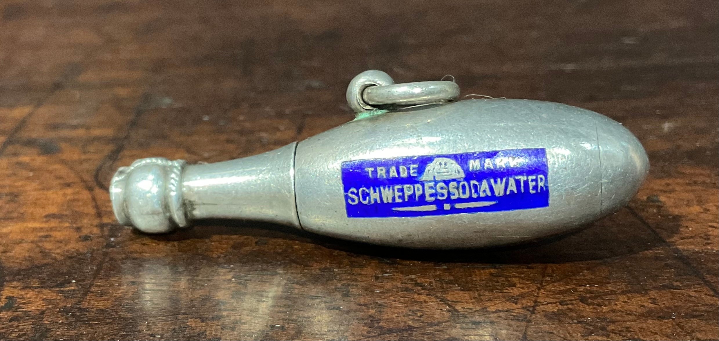  A Novelty advertising silver and enamel Schweppes soda water retractable pencil, c.1910