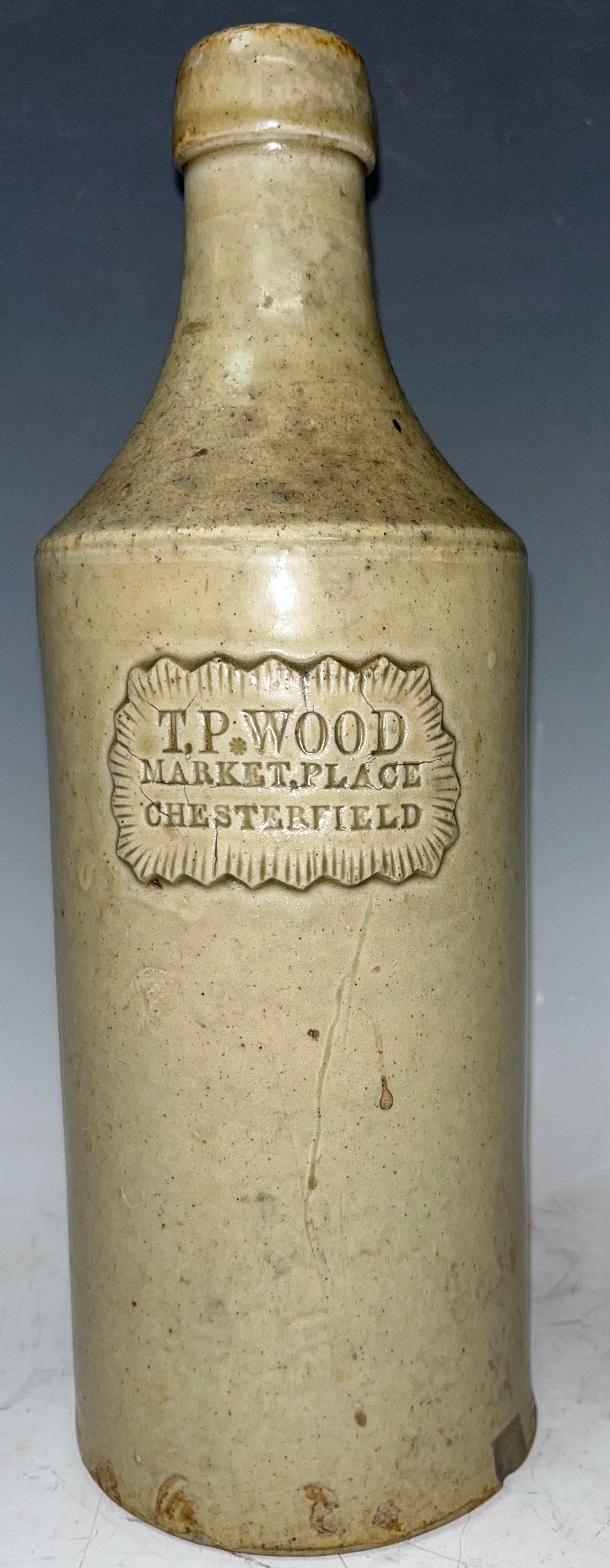 A slip glazed slab sealed stoneware porter, 'T. P. Wood, Market Place, Chesterfield', mid 19th century