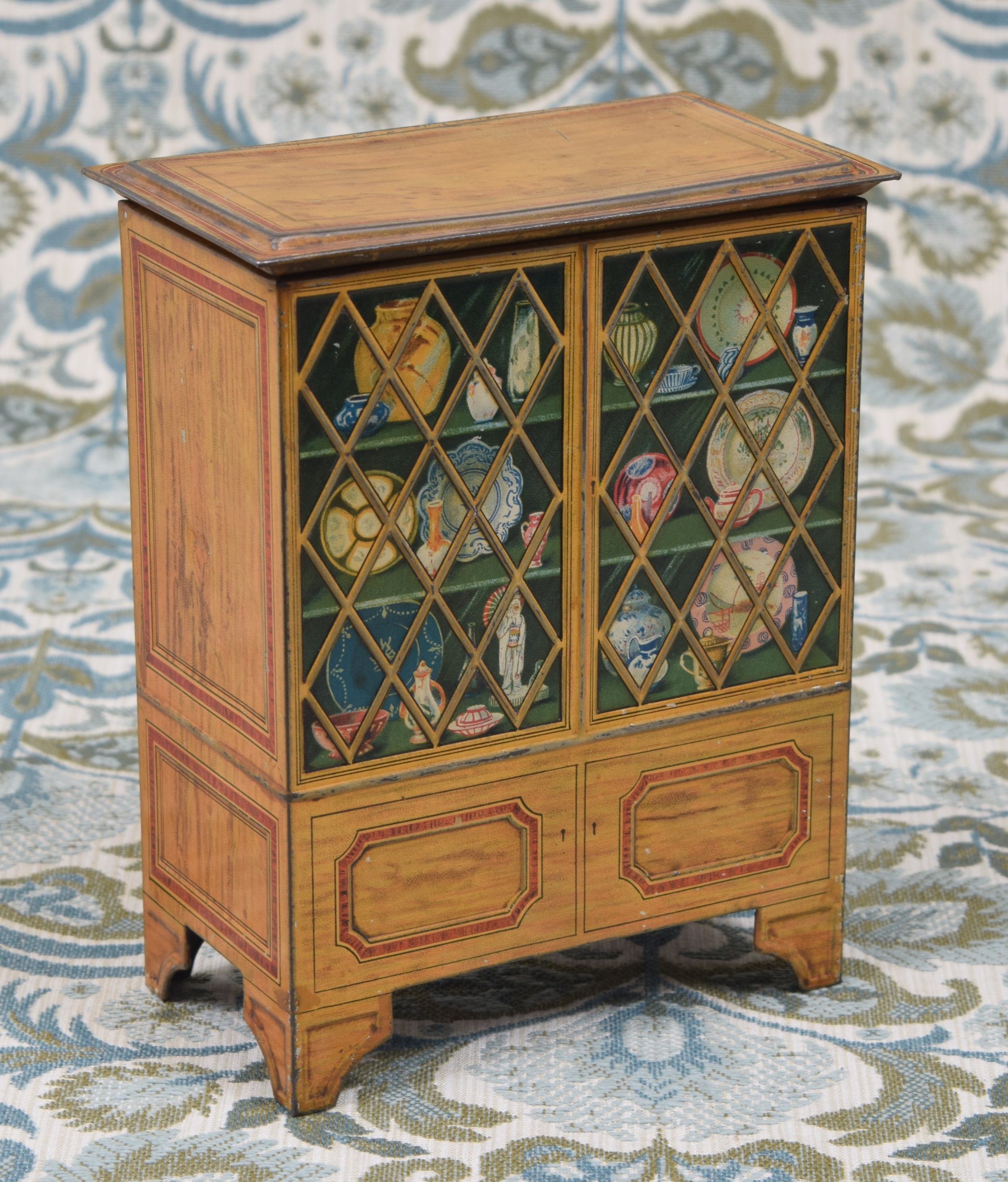 A Huntley & Palmers novelty biscuit tin in the form of a display cabinet