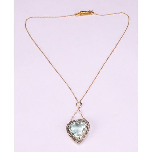 A trilliant cut aquamarine, diamond and gold coloured metal pendant,