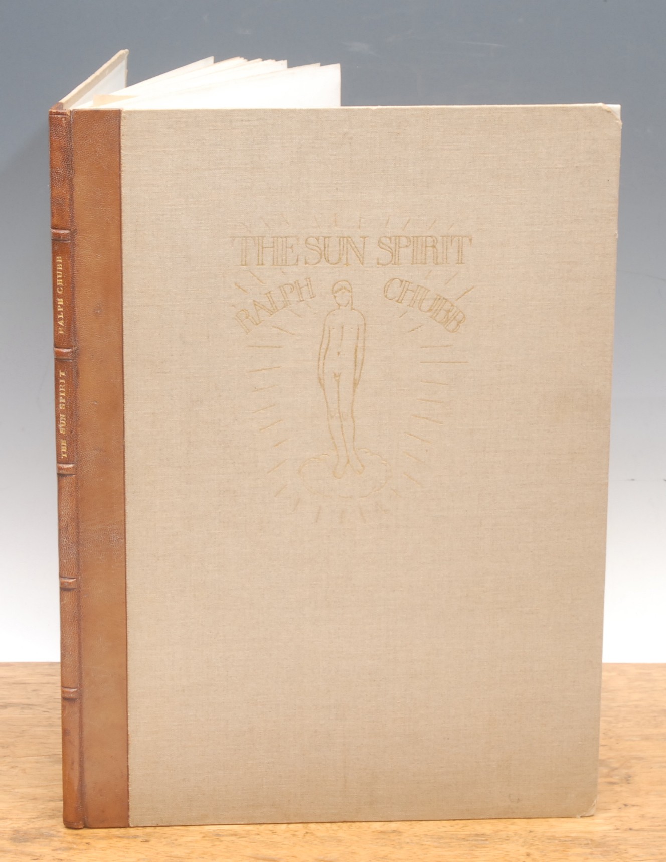 Book – Uranian interest: Chubb (Ralph Nicholas 1892-1960), The Sun Spirit: A Visionary Phantasy, 1st and only edn., Wolverton Hants., Fair Oak, Kingsclere, 1931 small folio, number one of only 24 printed, designed and decorated by the author, handprinted on Hollingworth paper, 46pp with 20 lithographic illus., bound by Ethel R. Chubb quarter undyed Nigger Morocco over Holland linen boards, vellum, tips, titles and figure of a youth blocked gilt to front board, 5 raised bands and gilt titles to spine, bkplt. Nicholas Wilde (1)
