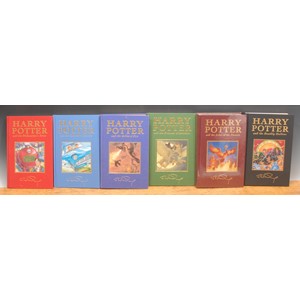 Harry Potter – Bloomsbury 8vo de luxe editions withy page markers: Harry Potter and the Philosopher’s Stone (1999), red cloth gilt titles, author’s autograph and mounted illustration. 6 volumes out of seven so issued:  Harry Potter and the Chamber of Secrets (1999), blue cloth, gilt titles, author’s autograph and mounted illustration; Harry Potter and the Prisoner of Azkaban (1999), green cloth gilt titles, author’s autograph and mounted illustration; Harry Potter and the Goblet of Fire (2000), blue cloth, gilt titles, author’s autograph and mounted illustration; Harry Potter and the Deathly Hallows (2007), gilt titles, author’s autograph and mounted illustration; Harry Potter and the Order of the Phoenix (1st edn., 2003),brown cloth gilt titles, author’s autograph and mounted illustration, still in publisher’s shrink film as sold (6)