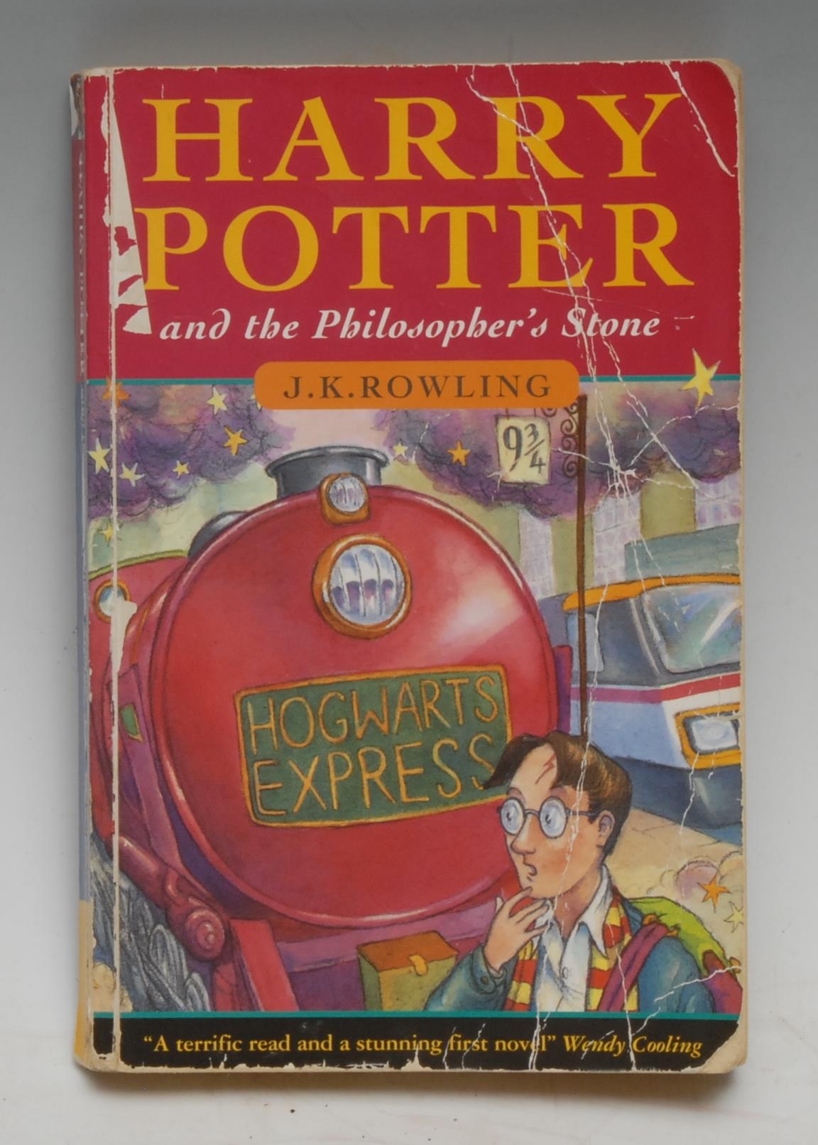 Rowling (J.K.), Harry Potter and the Philosopher's Stone, first paperback edition, first printing, London: Bloomsbury, 1997, "10 9 8 7 6 5 4 3 2 1" on publisher's imprint page, "1 wand" repeated on page 53,  and "Philospher's Stone" on lower-cover, original pictorial wrappers (creased and chipped), Tippexed ownership inscription to recto pastedown, infrequent corner creases, 8vo, [1]