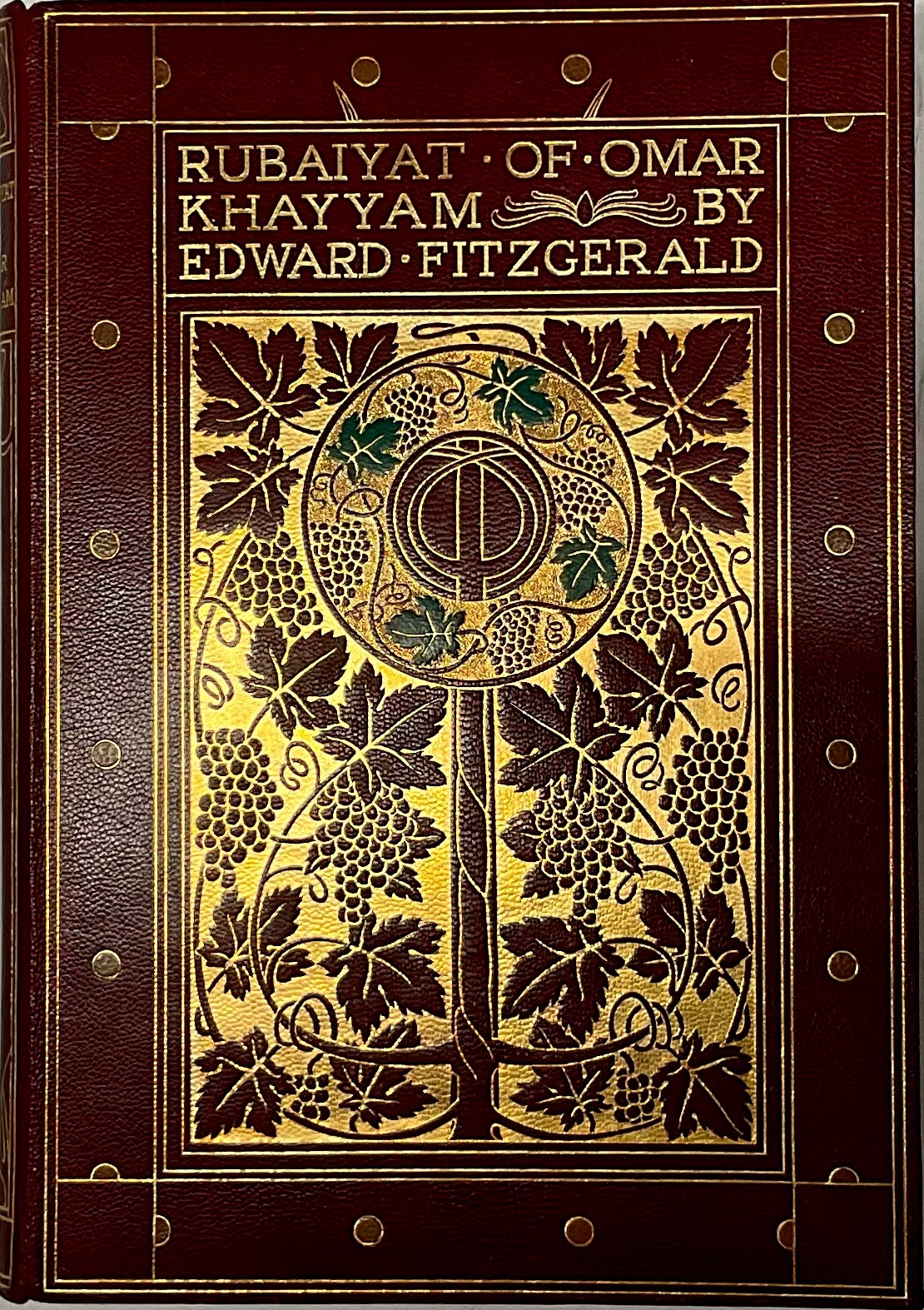 Fine Binding - Pogány (Willy, illustrator) & FitzGerald (Edward, translator), Rubáiyát of Omar Khayám, London: George G. Harrap & Co, 1909, lithograph-printed by McLagan & Cumming of Edinburgh, illustrated with 16 tipped-in colour plates within decorative calligraphic borders, finely bound in original red morocco gilt, the cover picked out with four green leaf leather onlays, top-edge gilt, others uncut, marbled endpapers, pictorial box en suite, 8vo, [1]    Provenance: The descendants of William Hamilton, an art-binder employed by the Harrap bindery.