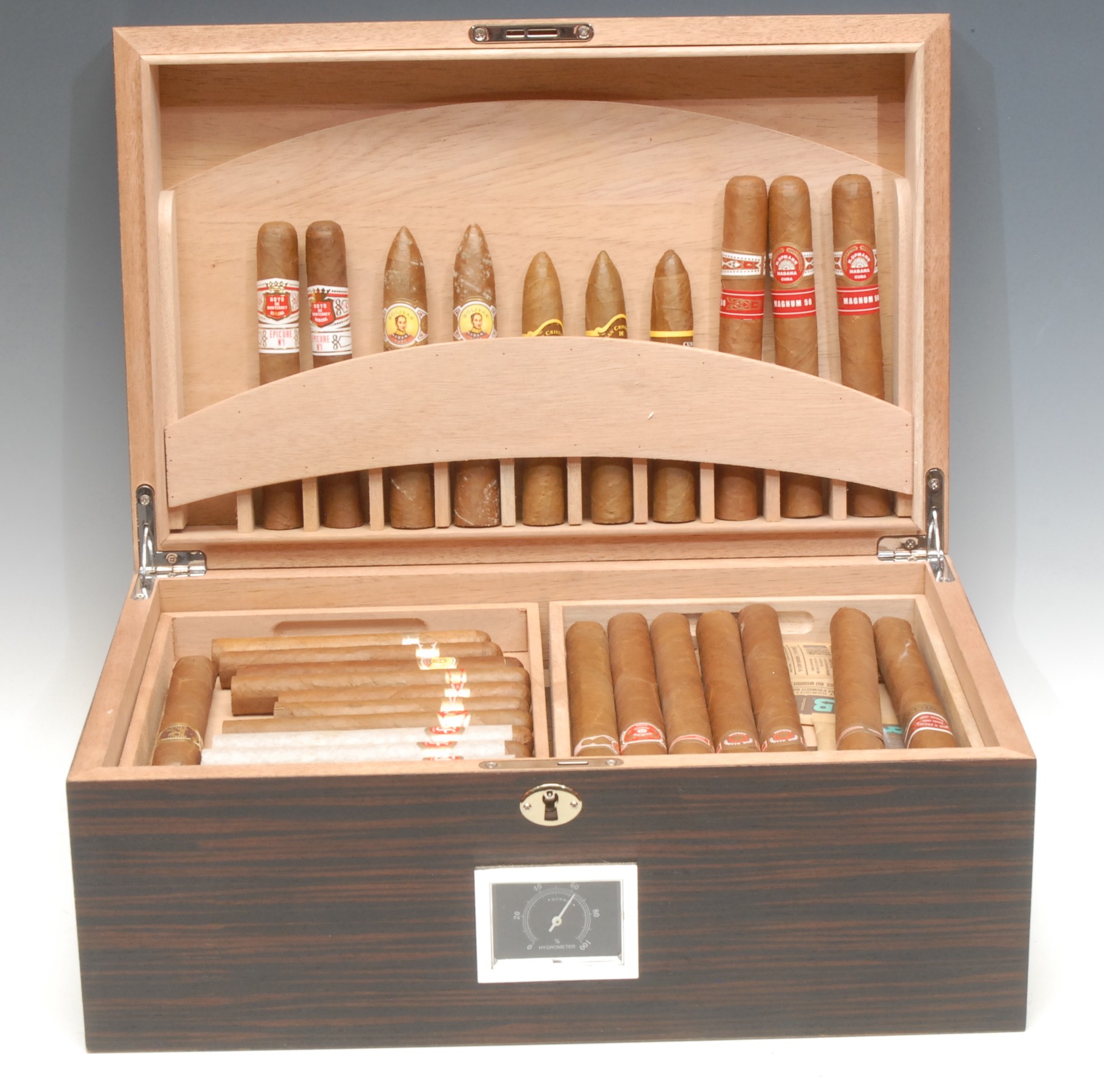 Smoking & Tobacciana - a 50-100 capacity smoker's box or humidor with dial hygrometer, enclosing an assortment of cigars including Cohiba, Ramon Allones, Fonseca, Punch, H. Upmann, an assortment of humidity control pouches, etc, the box 16cm x 38cm x 25cm, locking with a key
