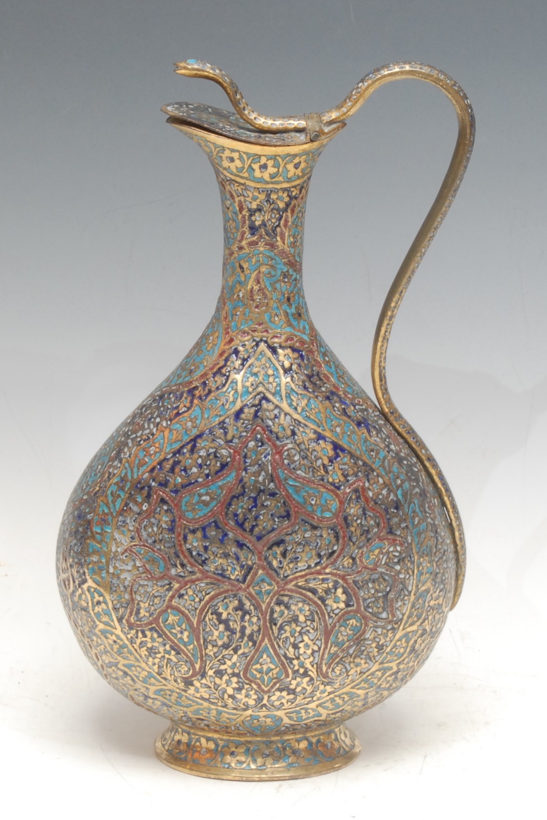 A Kashmiri enamel ewer, decorated in the Persian Islamic taste, cobra handle and finial, hinged cover, skirted base, 29.5cm high