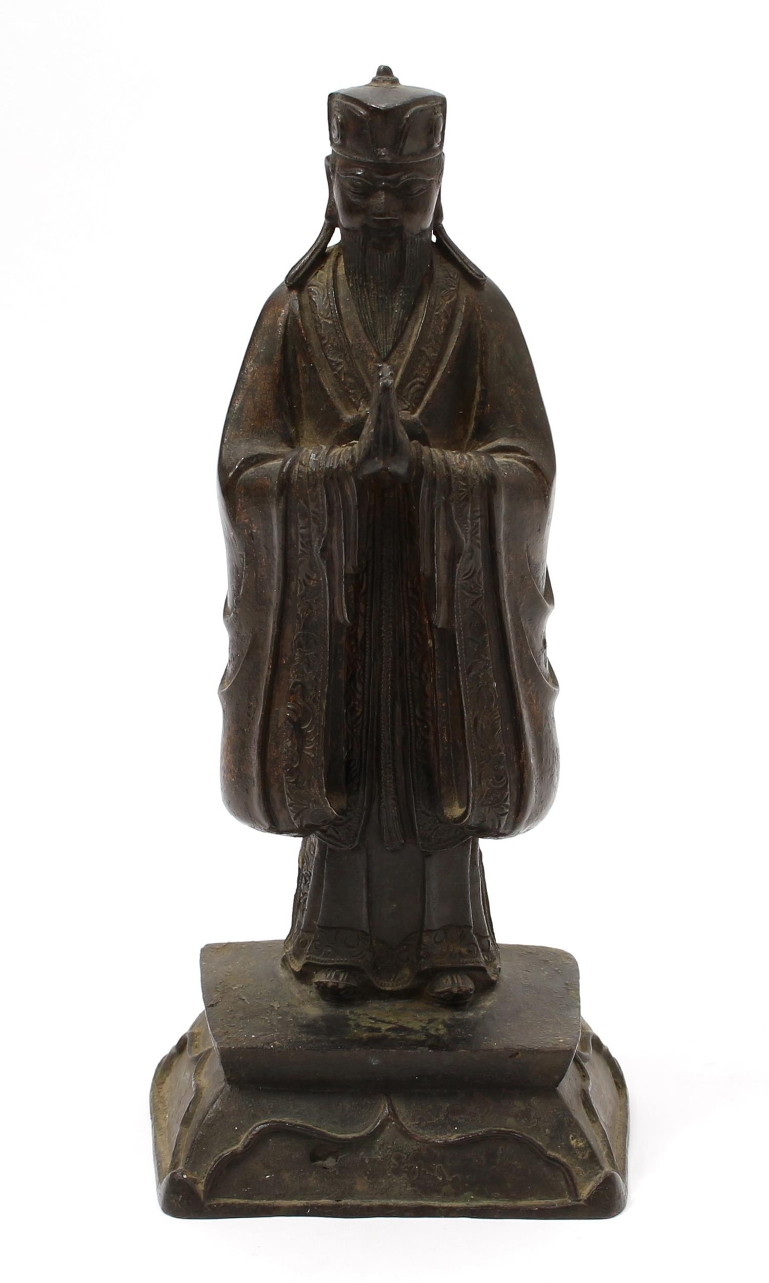 Chinese School (17th/18th century), a dark patinated bronze, of a Daoist Immortal, traces of gilding, 28.5cm high