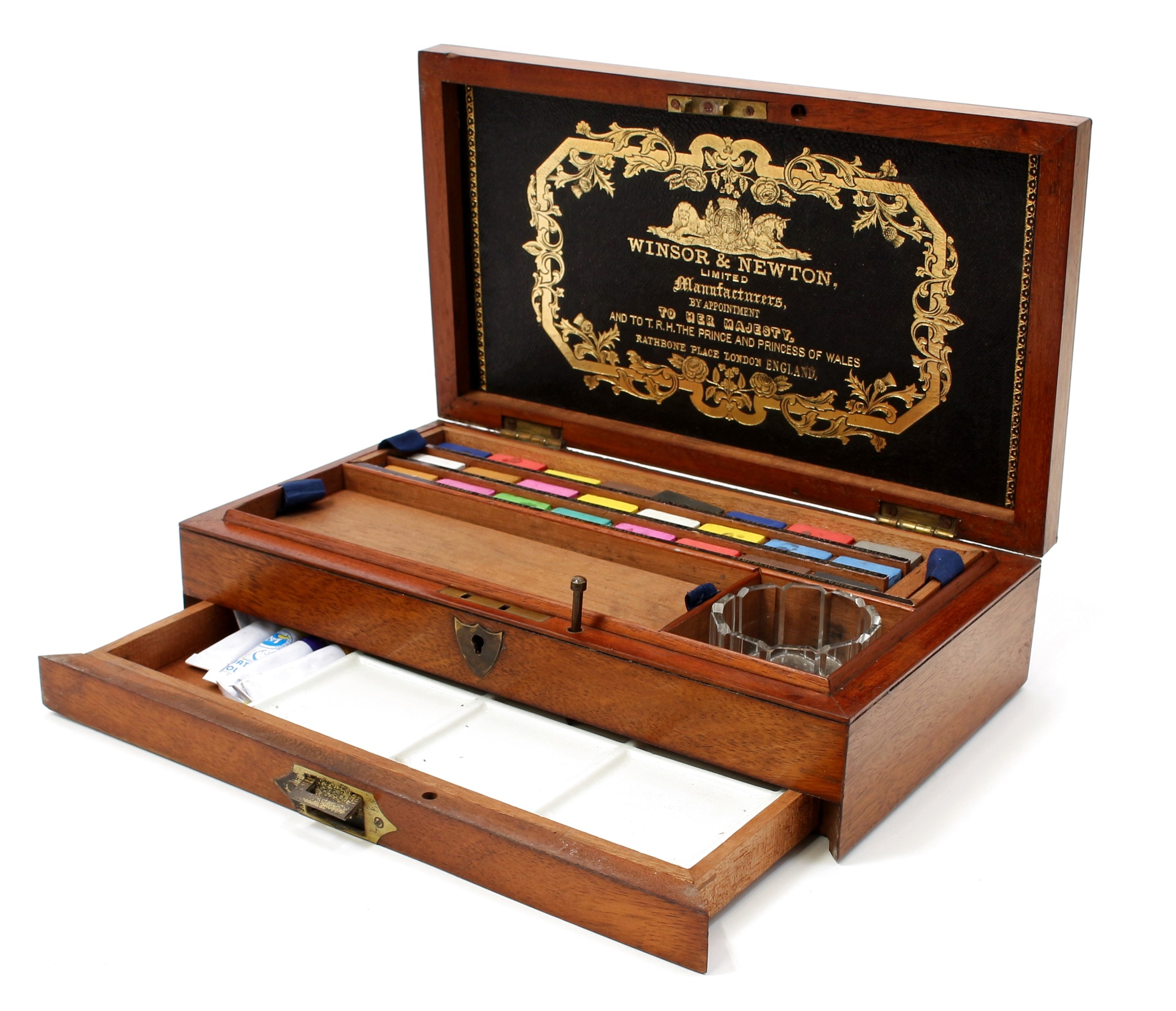 A Victorian mahogany artist's box, by Winsor & Newton Limited, London, hinged cover enclosing paint blocks, an arrangement of compartments and painting requisites, drawer to base with flush brass campaign type handle, 28.5cm wide, c.1880