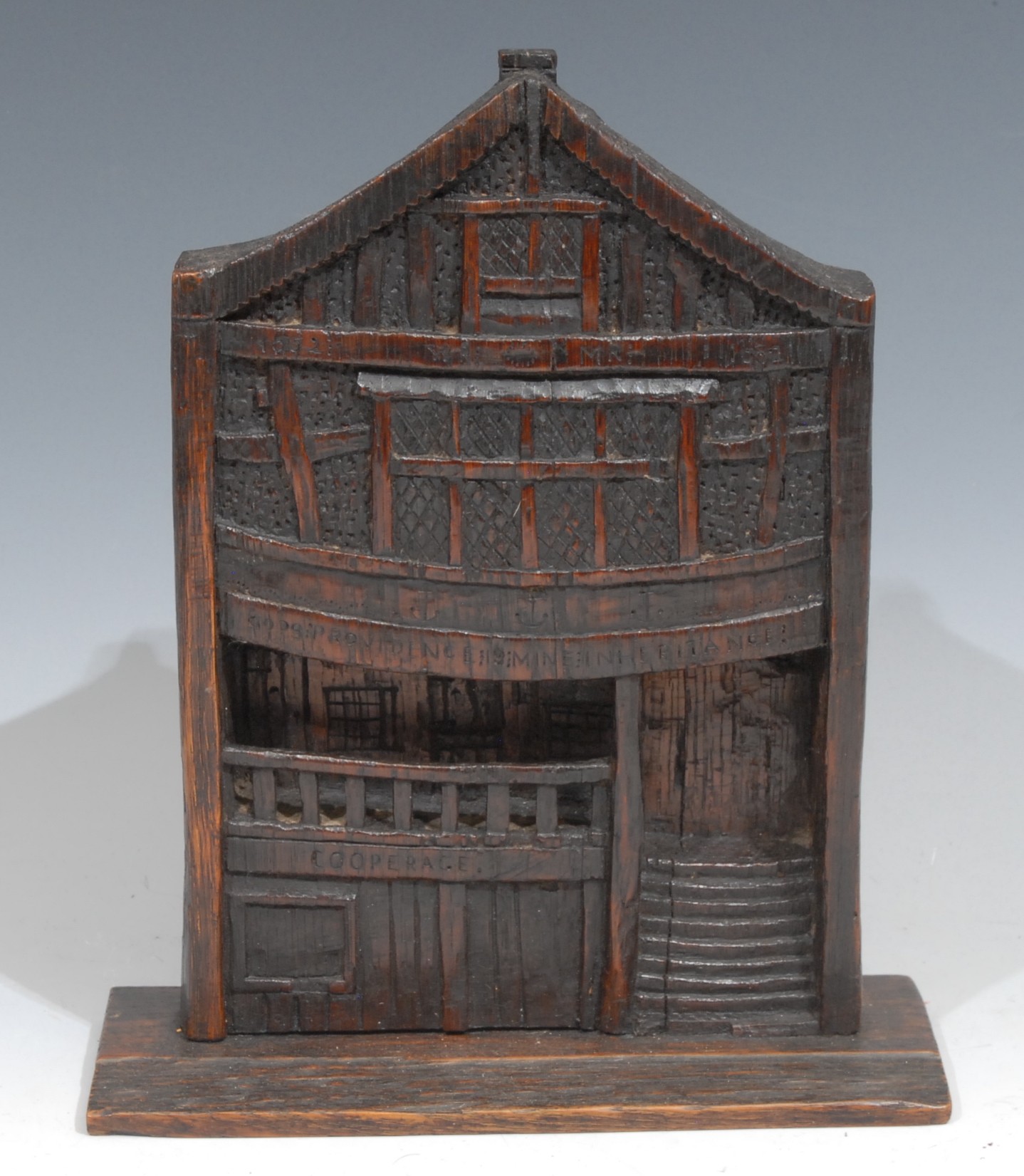 Architectural History - Folk Art - Treen -  Historic Buildings - an oak panel, carved with a view of God’s Providence House, Chester, the timbered facade inscribed to the beams God’s Providence Mine Inheritance, WR MR 1652, indistinctvMS label to verso, 22cm high  The name God’s Providence House is believed to derive from the legend surrounding the 14th century building which previously occupied the site that its occupants were the area’s only survivors of a plague outbreak in 1647-48.