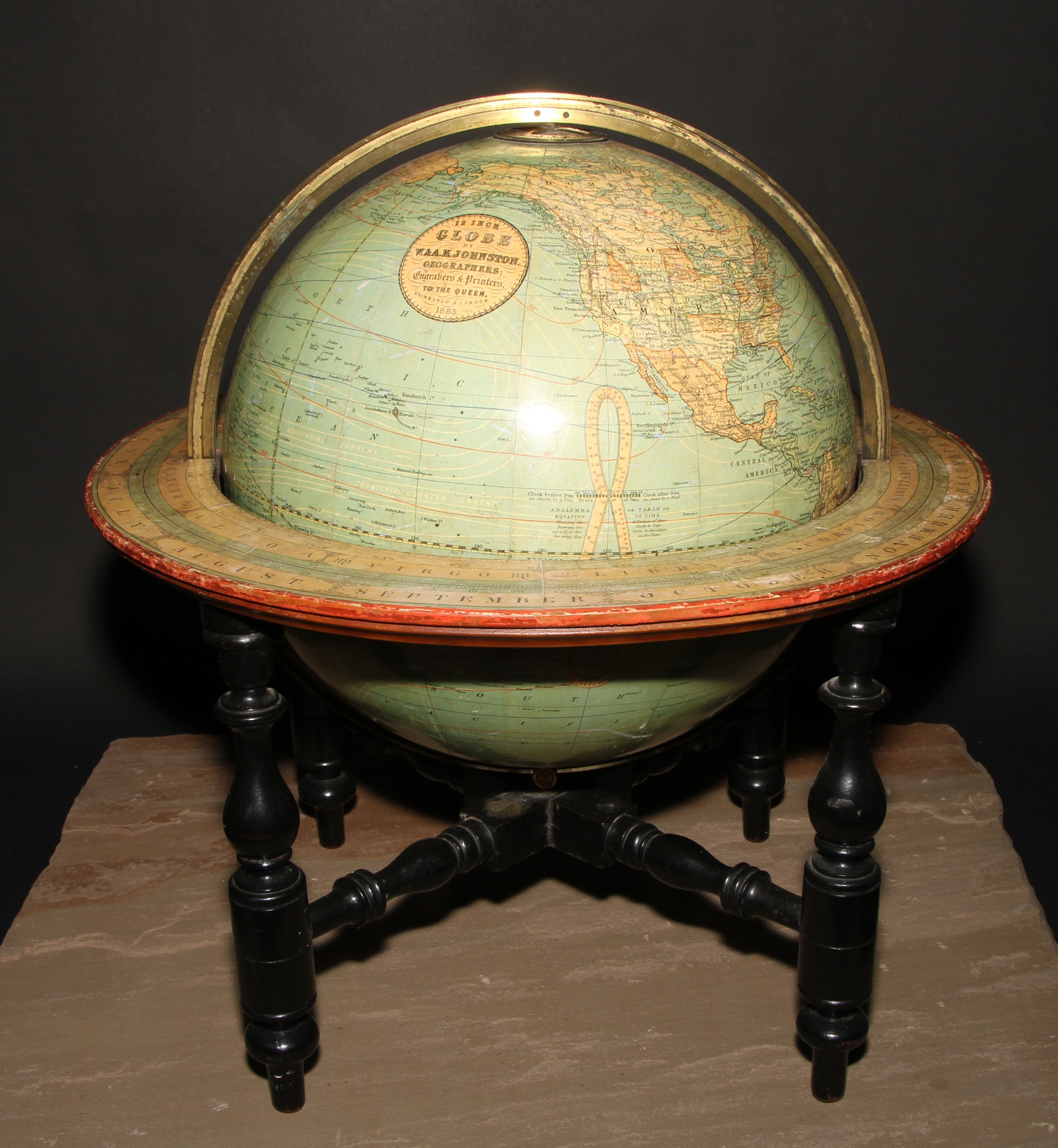 A late Victorian terrestrial globe, 12 inch Globe by W. & A.K. Johnston, Geographers, engravers & printers to the Queen, Edinburgh & London, 1883., turned ebonised underframe, 46cm high