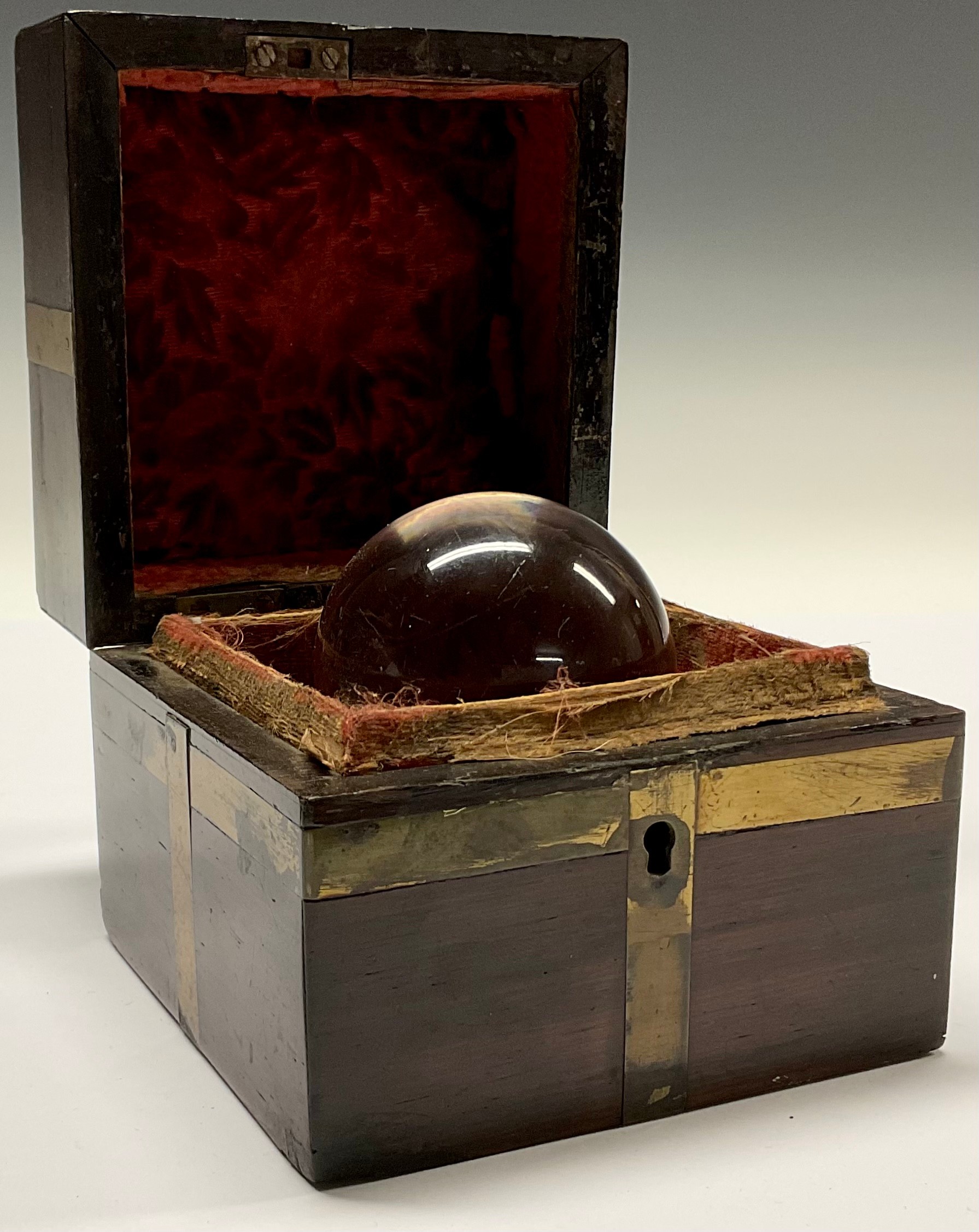 Mysticism and the Occult - a crystal ball, associated brass bound mahogany box, 10cm wide overall