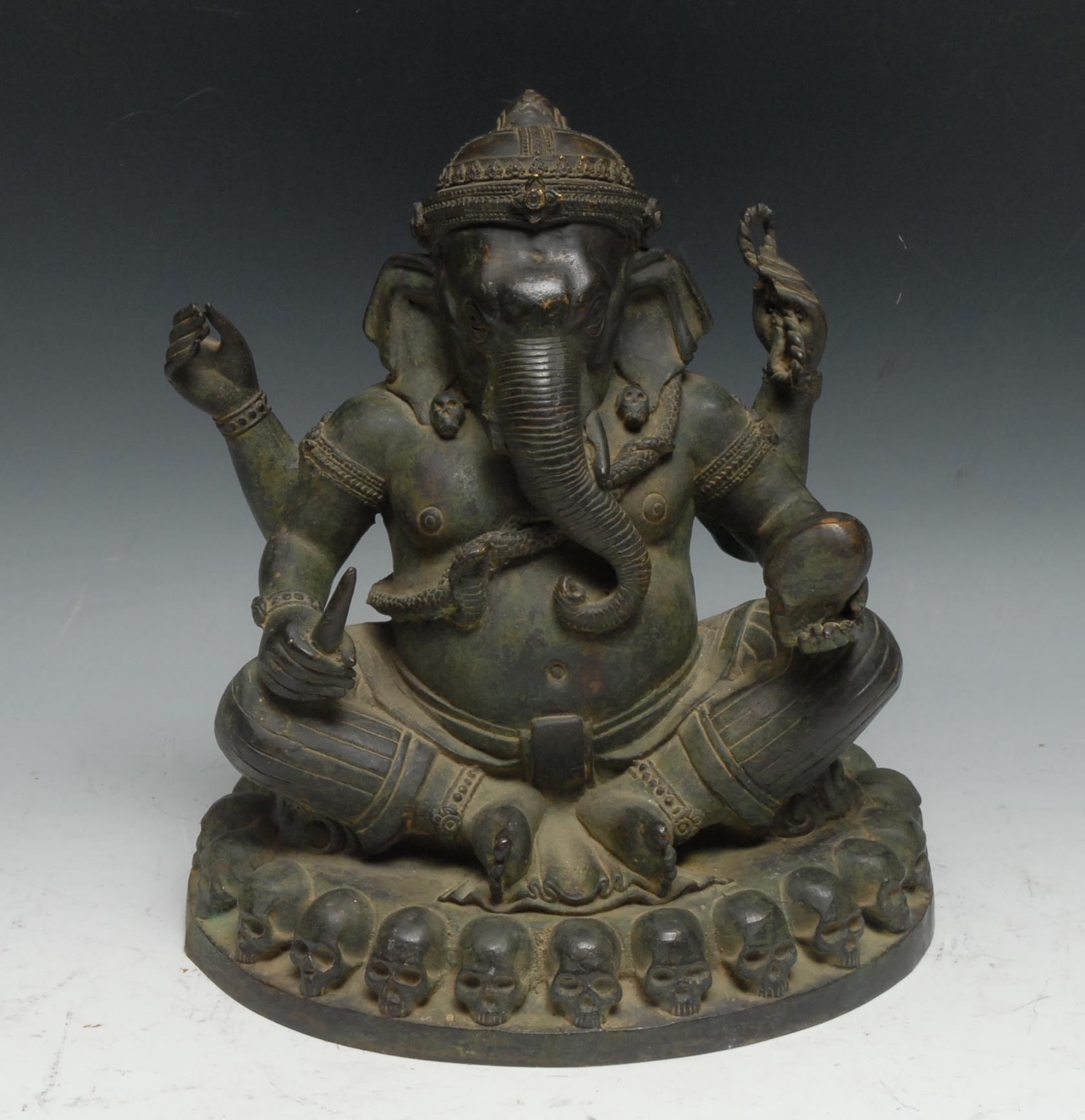 Indian School, a verdigris patinated bronze, Ganesh on a Throne of Skulls, 24cm high, probably 19th century
