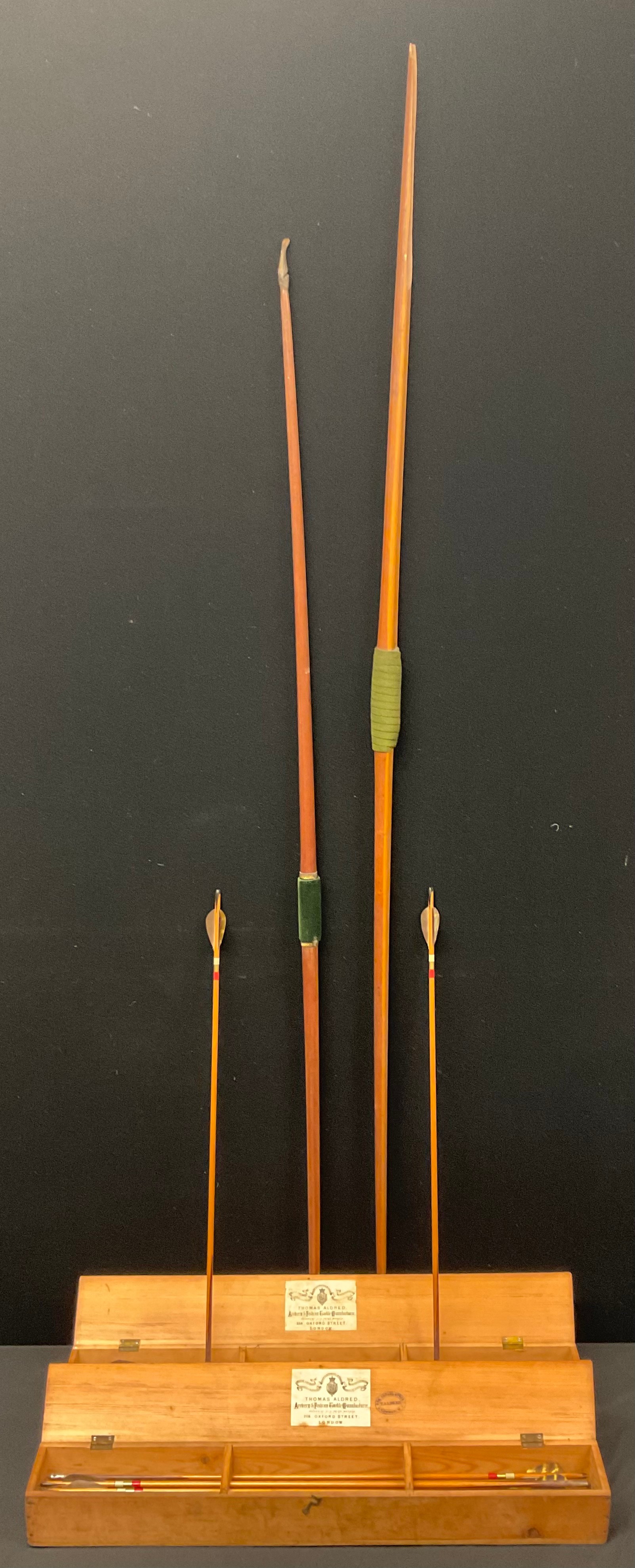 Archery - two dozen arrows, supplied by Thomas Aldred's Archery & Fishing Tackle Warehouse, Oxford Street, London, pine cases; a bow, by Peters & son, 219 Strand (faults); another (4)