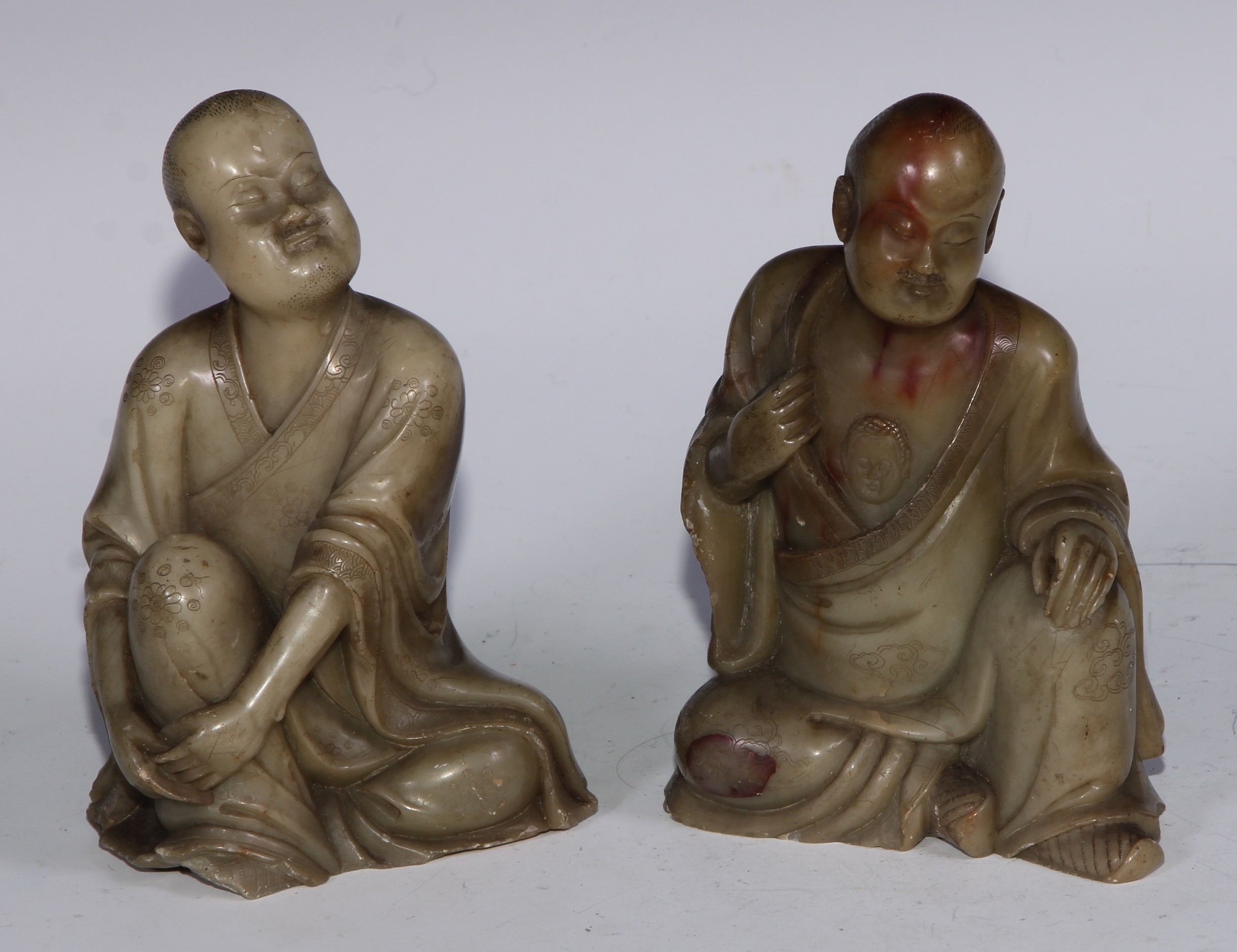 A Chinese soapstone figure, of a monk, seated, parting his robe, Buddha displayed on his chest, 12.5cm high; another, similar (2)