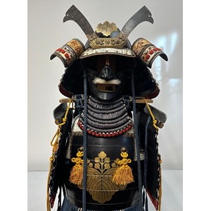 Suit of Japanese Samurai Armour. Complete with Kabuto Helmet with Maedate (Front decoration), Menpo face armour mask, Dō (cuirass), Sode (shoulder guards), Kusazuri (skirt of plates attached to the cuirass),  Kote (armored sleeves), Haidate (thigh protection),  Suneate (shin guards), plywood stand, etc all contained in a black transit box.