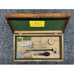 Wooden Pistol Box with Tranters Patent Bullet Mould in .30cal, Nipple Wrench, Wooden Cleaning Rod, Brass Ely Percussion Cap Tin (empty) spare parts for a Powder Flask. Size 368mm x 203mm x 60mm. No key.