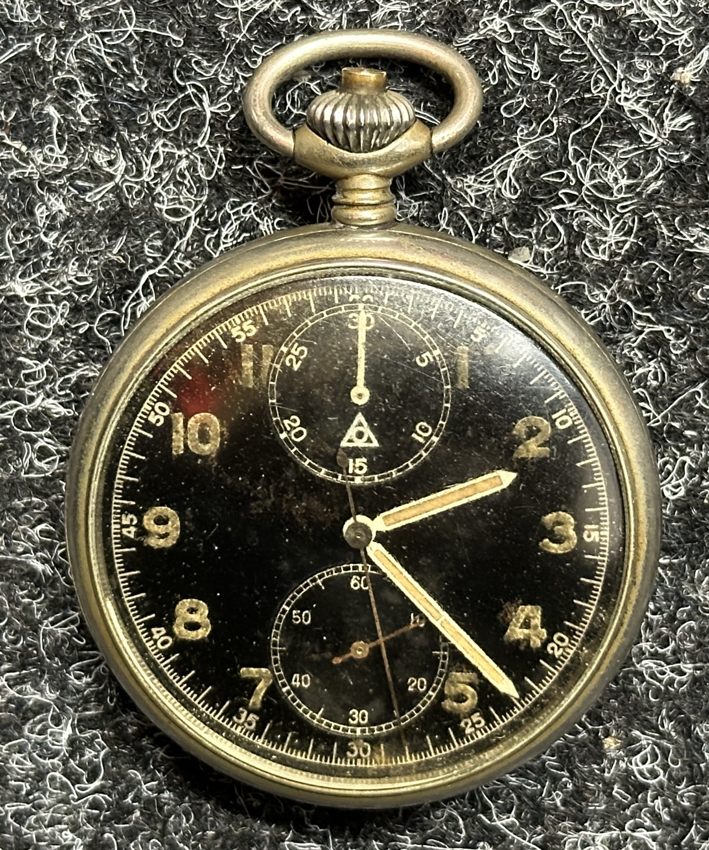 WW2 Third Reich Kriegsmarine Minvera 19/CH9 Chronograph Pocket Watch. Black dial with Luminous Arabic Numerals. Seconds hand with additional separate dials for seconds and 30 minute register. Chrome plated steel case. Reverse is engraved with Eagle M Navy mark along with "Artl. 5980". Runs and ticks, would recommend a clean and service.