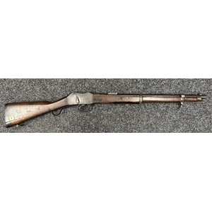 Martini Henry Carbine MKII .450/557 cal. with 525mm long barrel. No visible serial number. Maker marked and dated "Enfield 1885". Working action.  Brass butt identification disc marked "R.I.C 390". (RIC = Royal Irish Constabulary). Stock marked with double Broad Arrow sold out of service marks along with receiver and barrel. Complete with cleaning rod. Overall length 955mm. NOTE: Section 58 (2) Obsolete Calibre, no licence rquired in the UK.