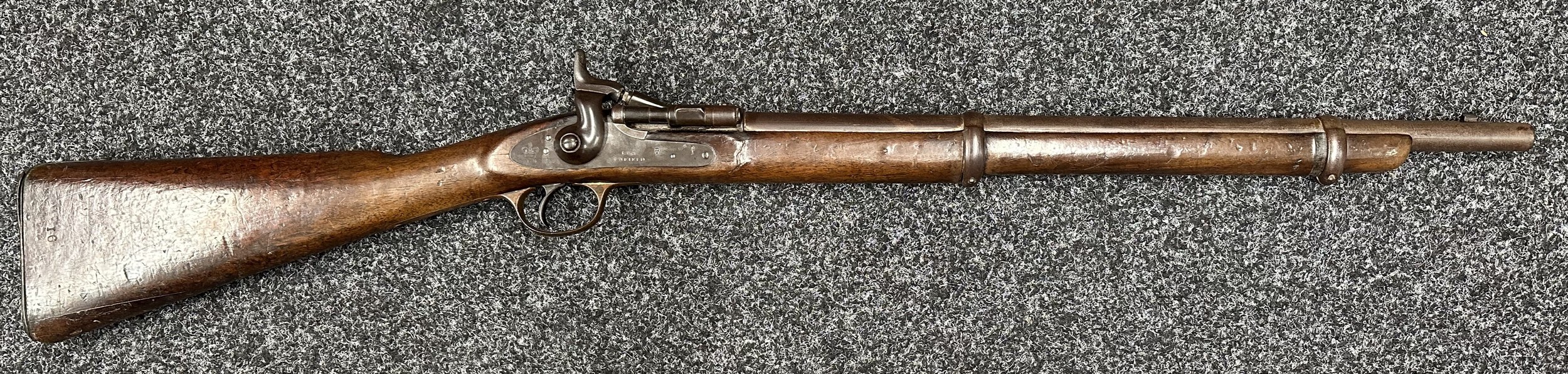 .577 Enfield Snider Conversion Artillery Carbine, lock marked with Crown VR along with Enfield 1858, no visible serial number. Working action. Barrel length 545mm. Overall length 1015mm. NOTE: Section 58 (2) No licence required in the UK. Provenance:  By Repute...   This rifle came from the old Nottingham Prison, which was demolished in 1900. My neighbour, Bill Swanwick, was allowed to play with this in his childhood (Bill was born in the 1930s, and lived on Goldsmith Street, where his father was a maker of surgical appliances). Bill and his friends used it when playing cowboys and  Indians outside in the street. One day he was brought back to the shop with the gun by the local policeman, who suggested to the father that it would be better if he didn't play with it outside again.