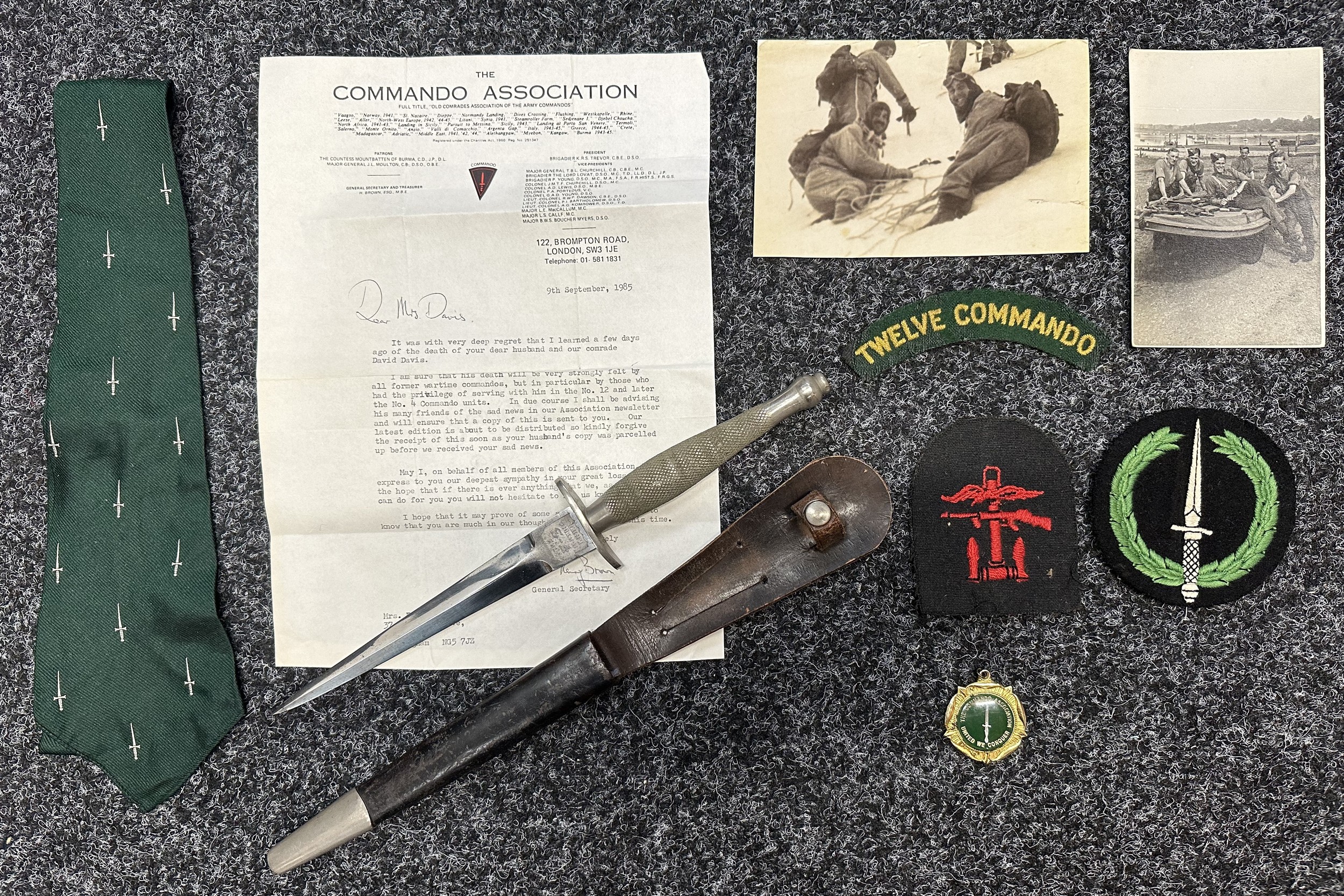WW2 British 1st Pattern Fairbairn-Sykes Commando knife with provenance to Pte David Davis ex No 12 and No 4 Commando. New to the market. Double edged blade 171mm in length. Etched panels with "The F-S Knife" and "Wilkinson  Swords Co Ltd London". Blade is in very good condition. Overall length 300mm. Scabbard is the correct first pattern style with retaining strap with working press stud fastner. Both tabs to the scabbard have been very carefully period removed. Correct nickle plated chape. Also including is the lot are one of his original 12 Commando shoulder titles, a single Combined Operations formation sign, Commando Association tie, blazer badge and medallion togther with a letter of condolence from the association on his deather in 1985. Plus two photos, both with captions to the reverse. Background detail: Pte Davis was on the Lofoten Islands Raid. He was invalided out of the Commandos prior to D Day. When asked by his family if he had used the knife his reply was "We were Commandos...".