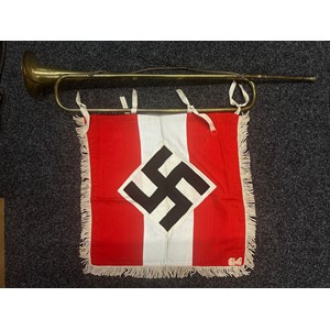 WW2 Third Reich HJ Trumpet and HJ Trumpet Banner. The trumpet is maker marked for "Sachs. Musik-Instrumenten Manufactur. Schuster & Co. Markneckirchen". With hanging cord. Banner has four tie tapes. White fringe to edges. Multipart construction and retains it's original RZM label sewn in place.